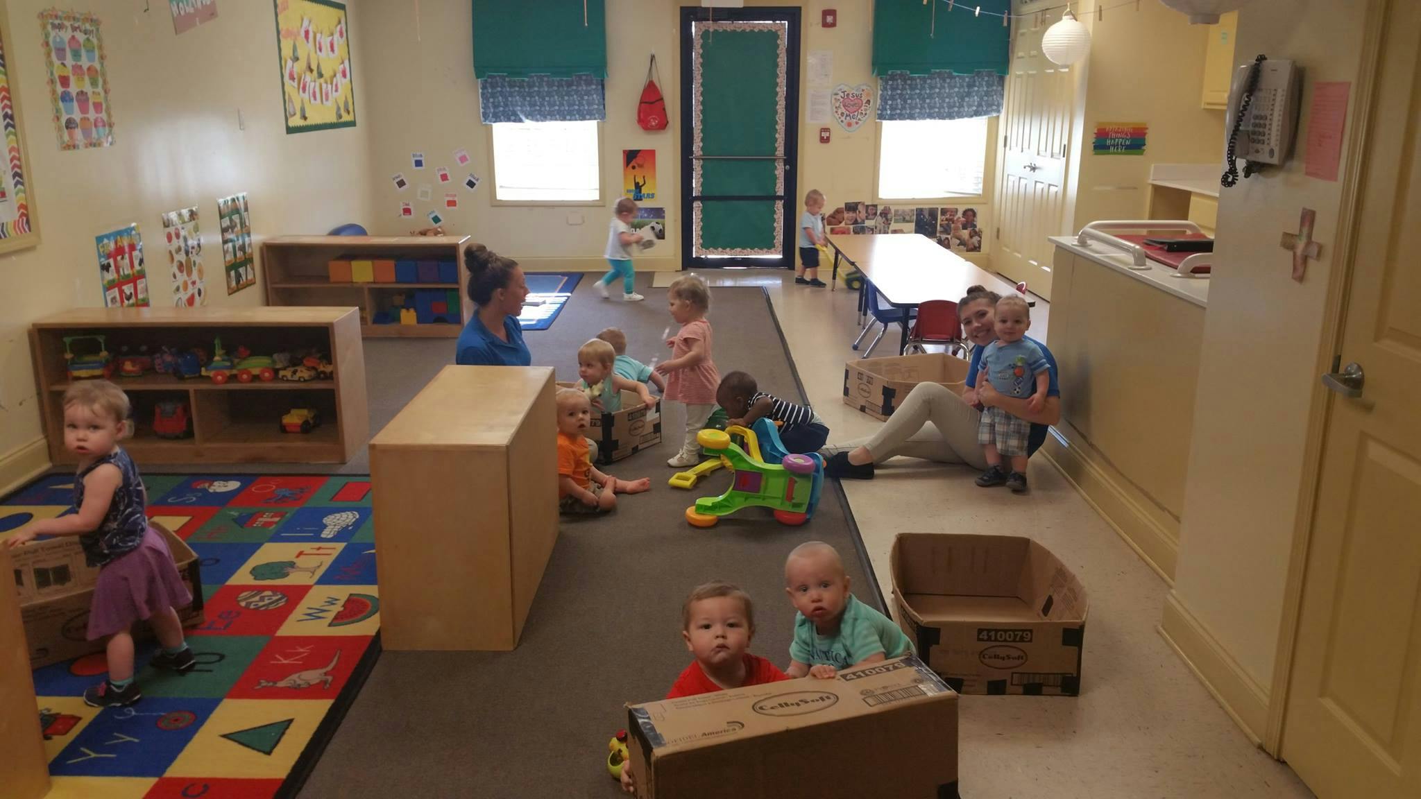 Adults and children playing in a classroom