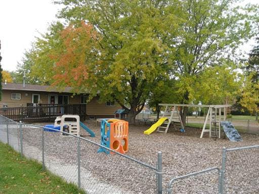 Outdoor playground with swings, slides, and play structures