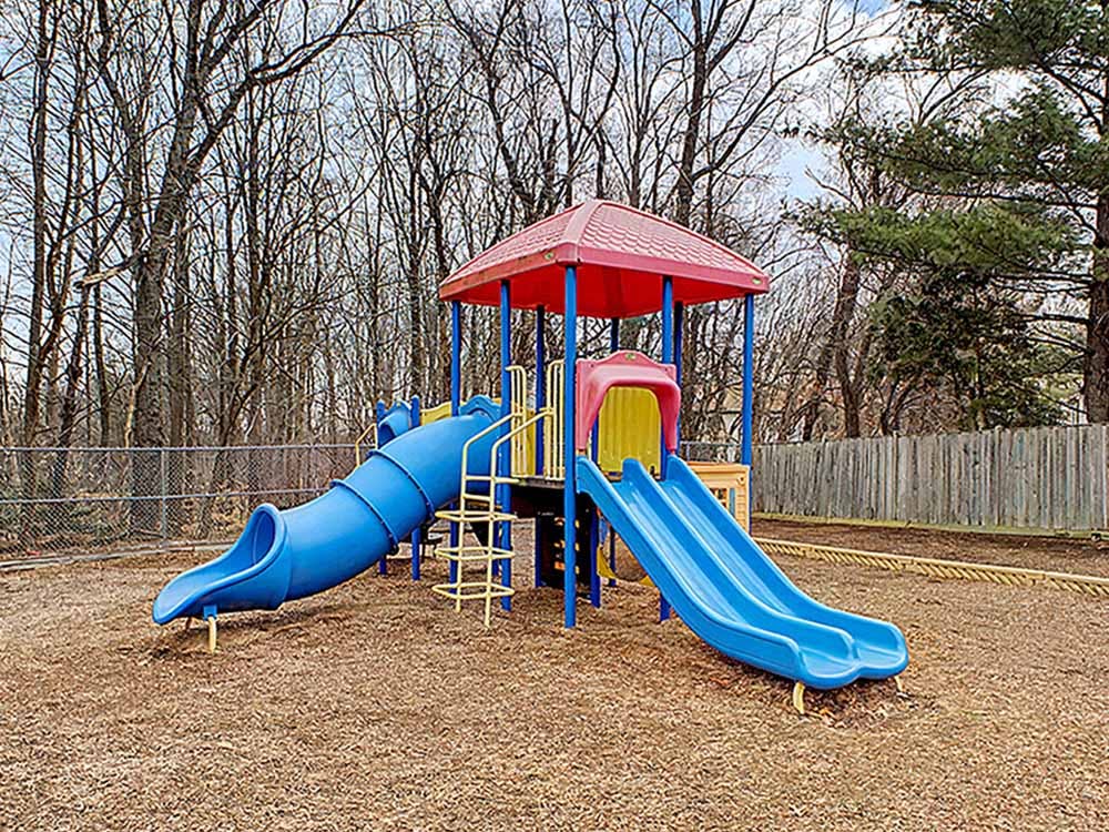 Colorful playground with two blue slides and a red roof
