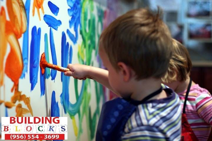 Child painting on a canvas with a brush