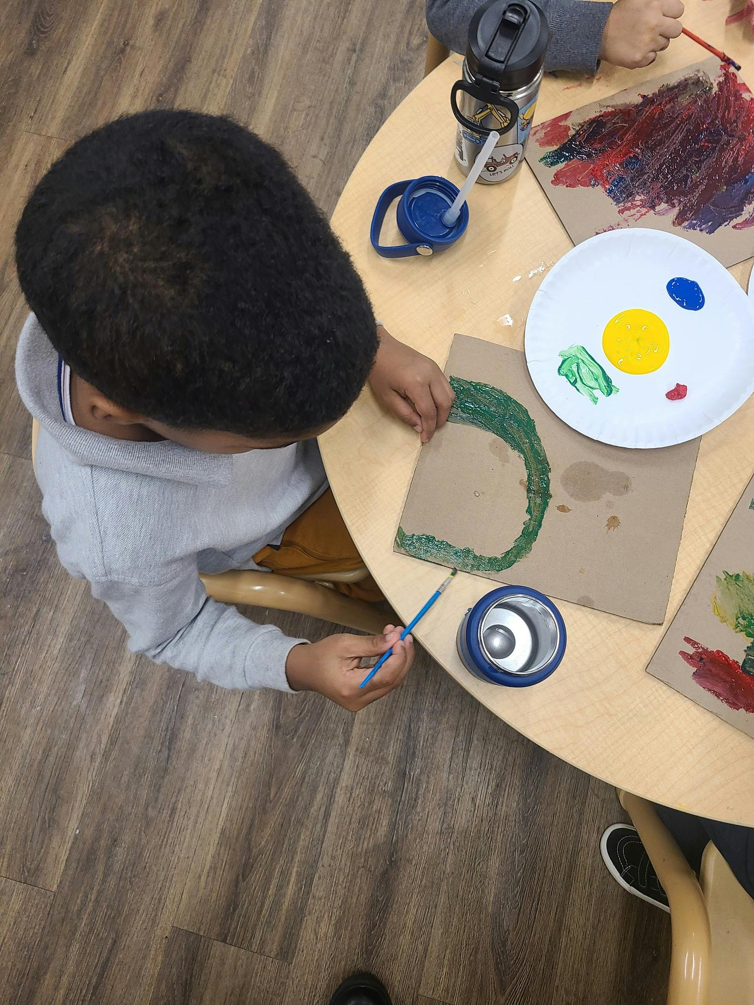 Child painting at a table