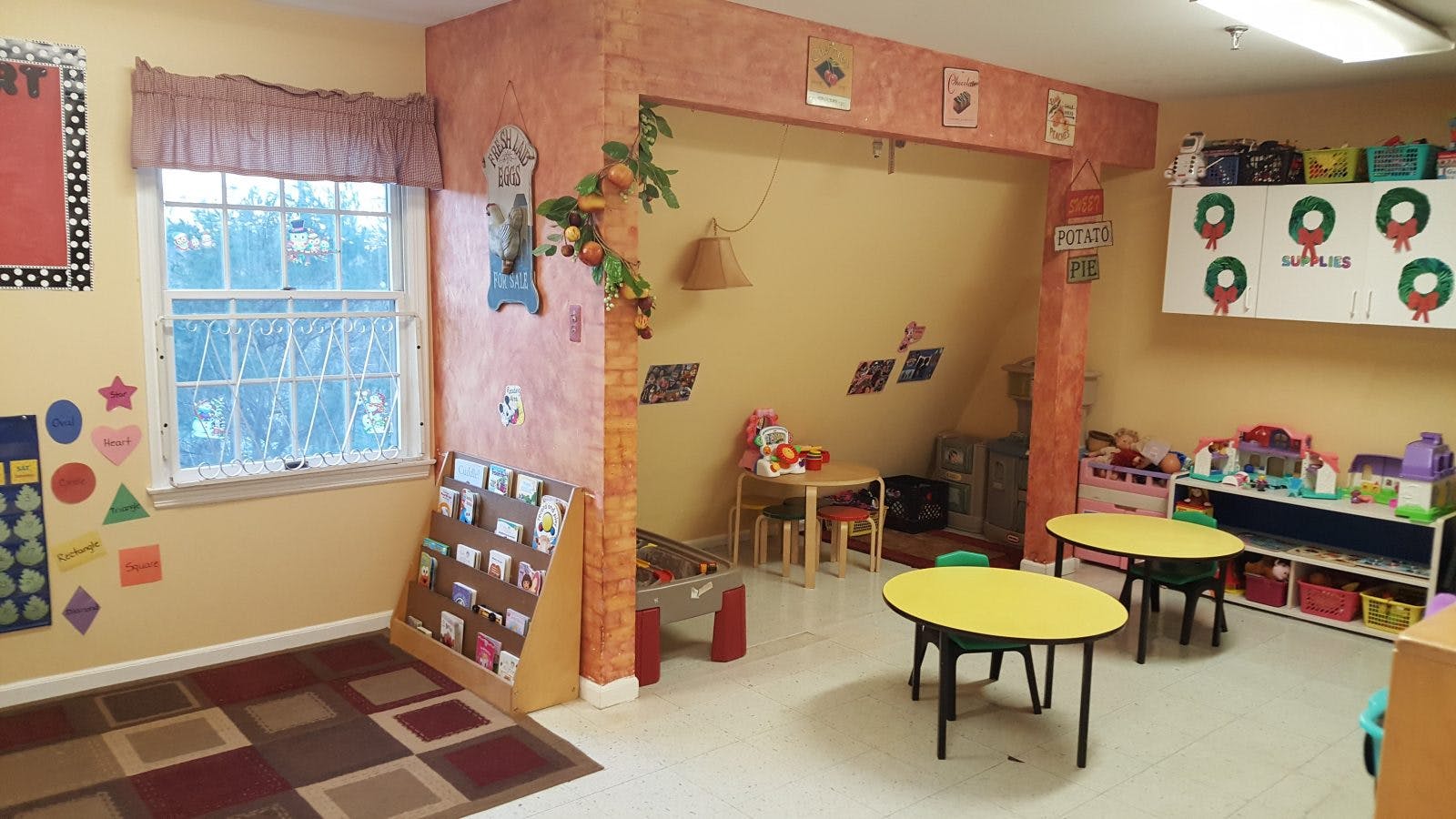 Empty classroom with small tables and chairs