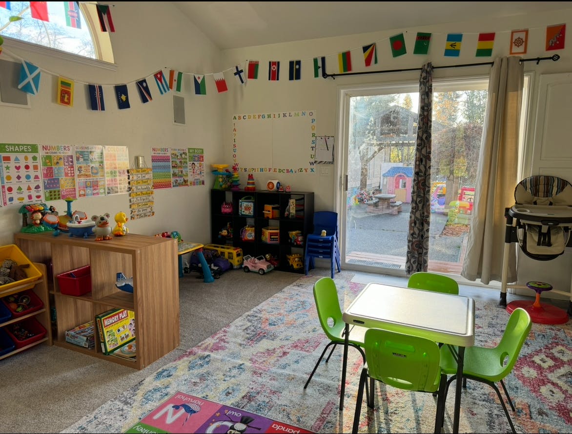 Playroom with small table and chairs, toys, and decorations