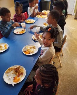 Children eating at a long table