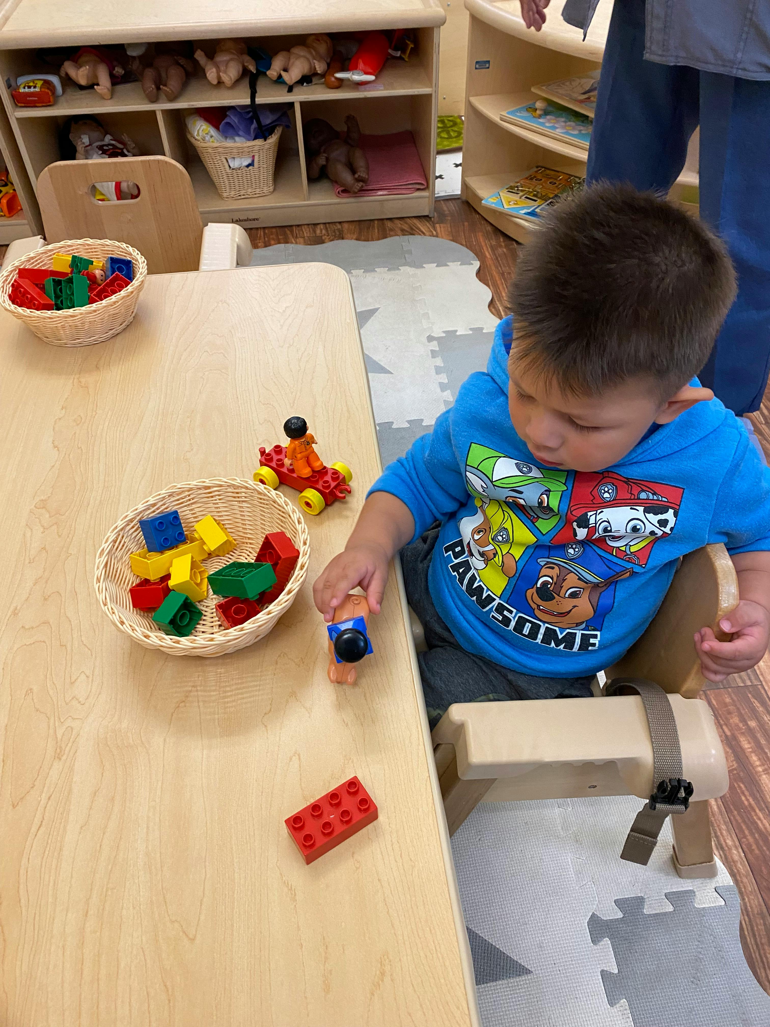 Child playing with building blocks at a table