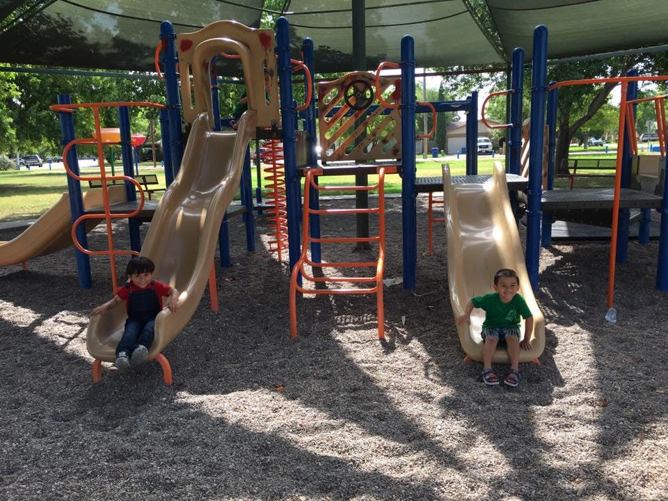 Two children on playground slides