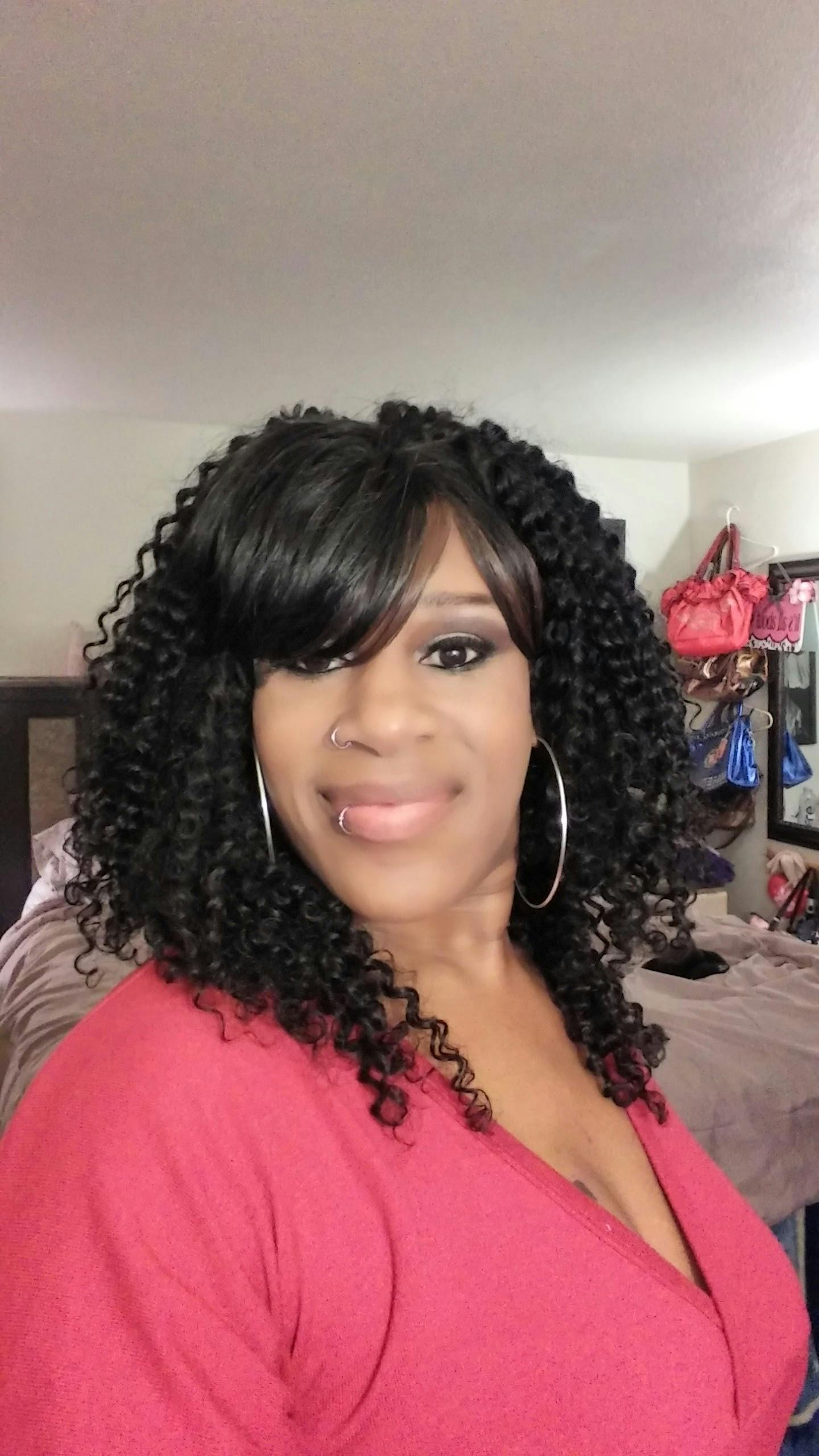 Person with curly hair and hoop earrings