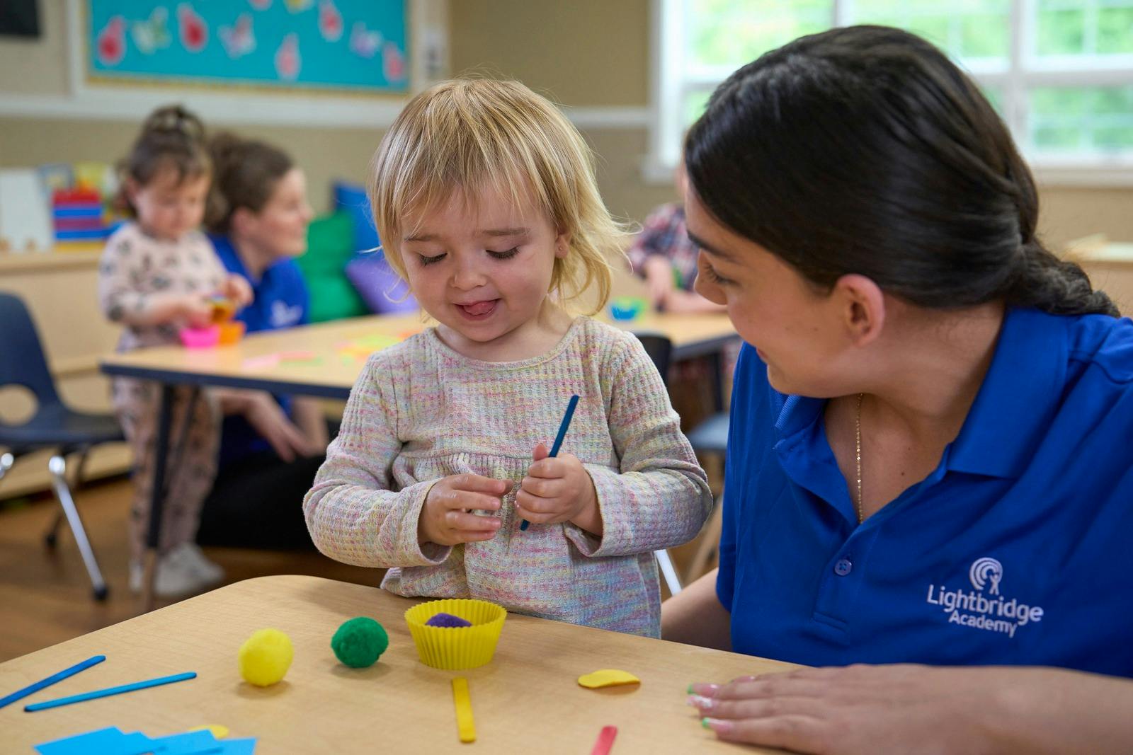 Adult and child playing with modeling clay at a table