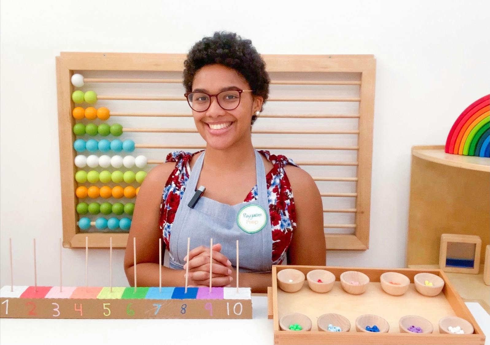 Person in glasses and apron with educational toys