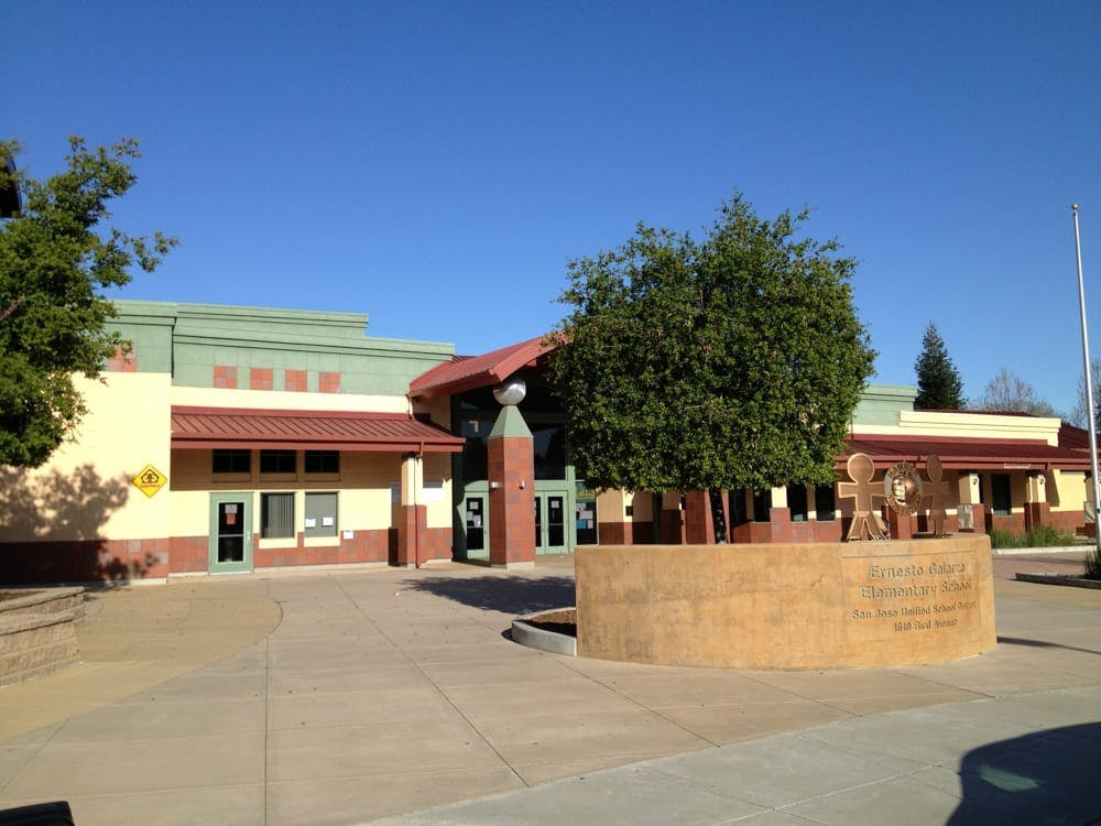 Exterior of a building with a light green and tan facade