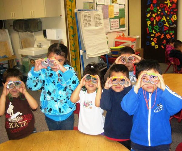 Group of children looking through toy binoculars