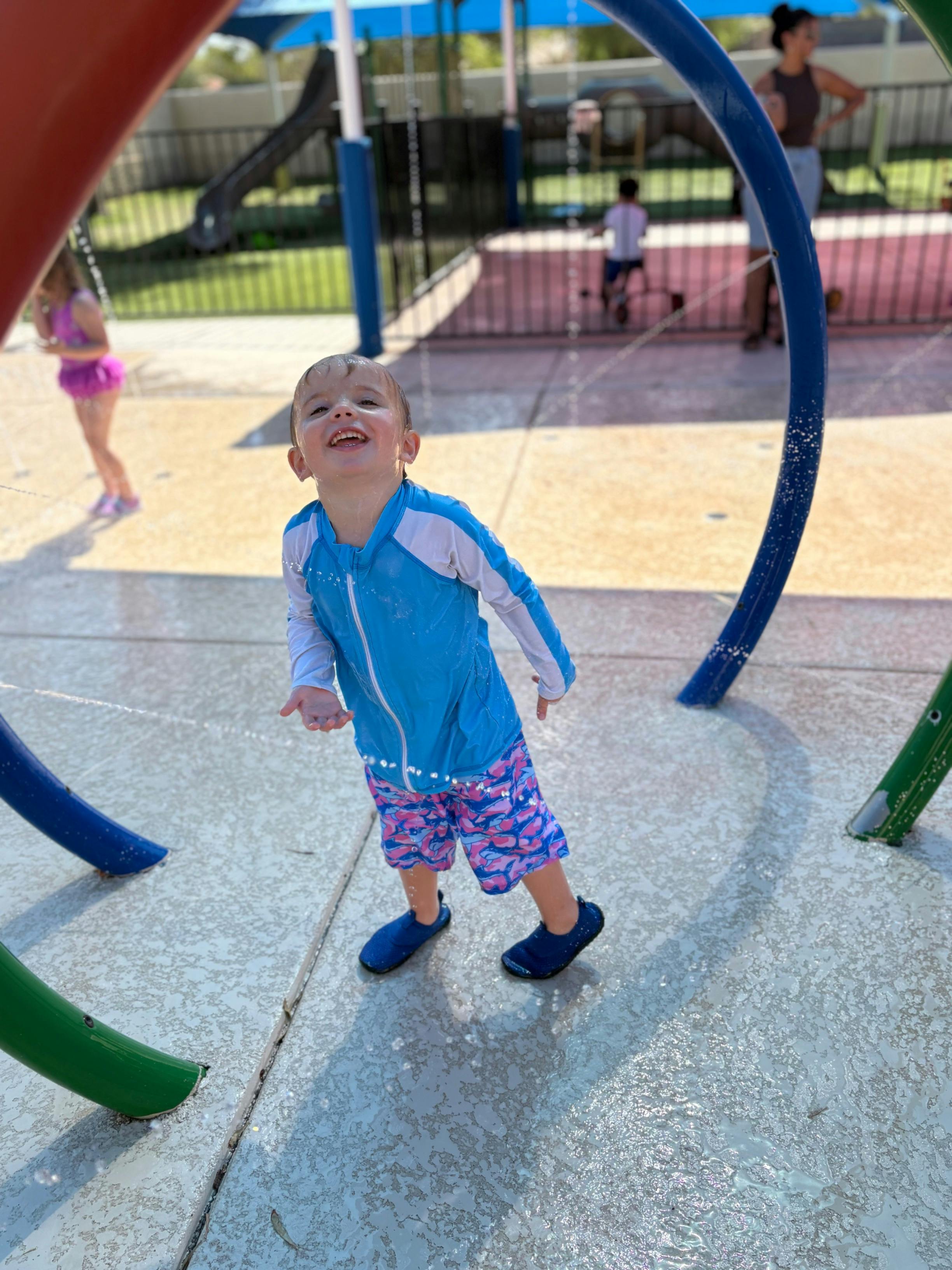 Child playing in a water splash park