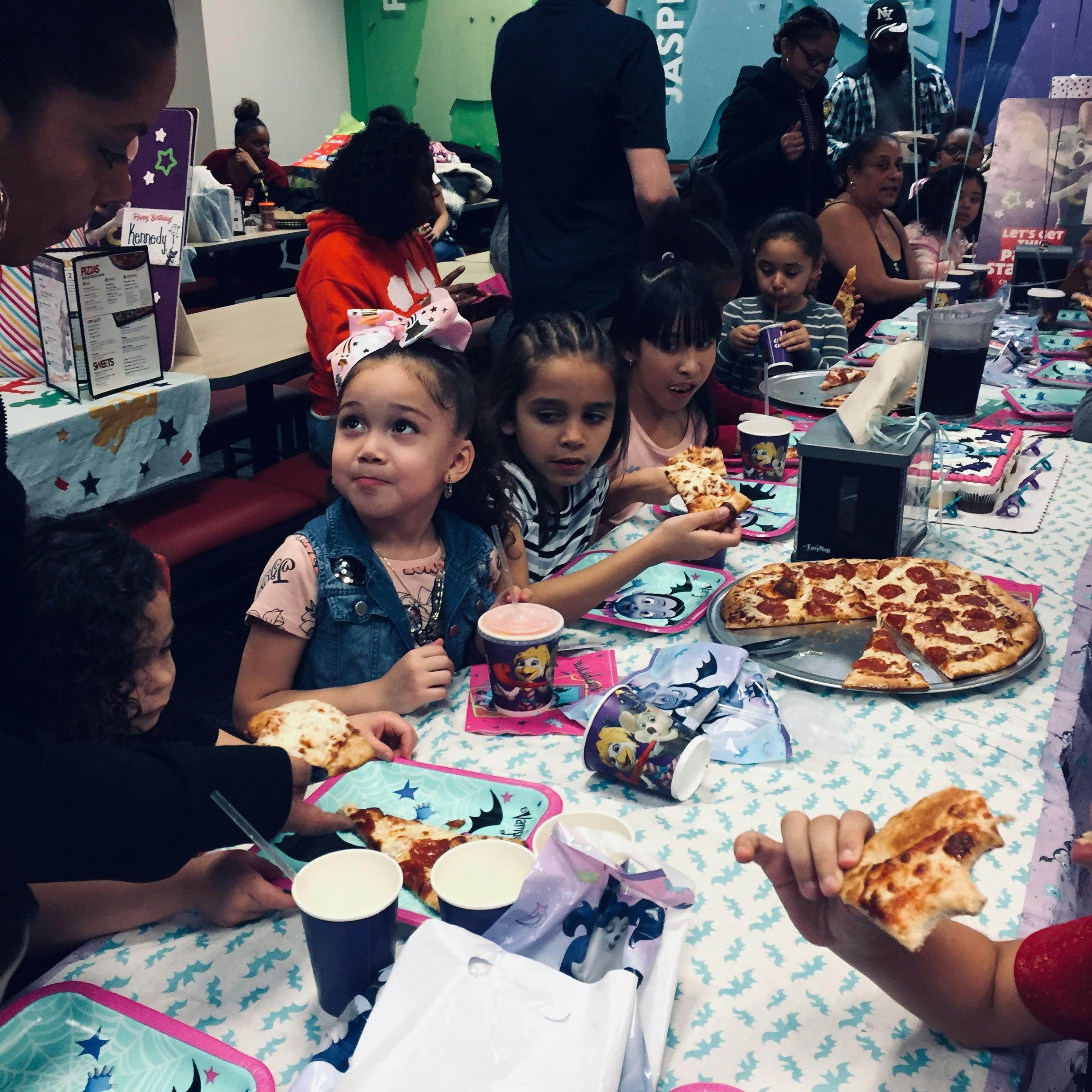 Children eating pizza at a table
