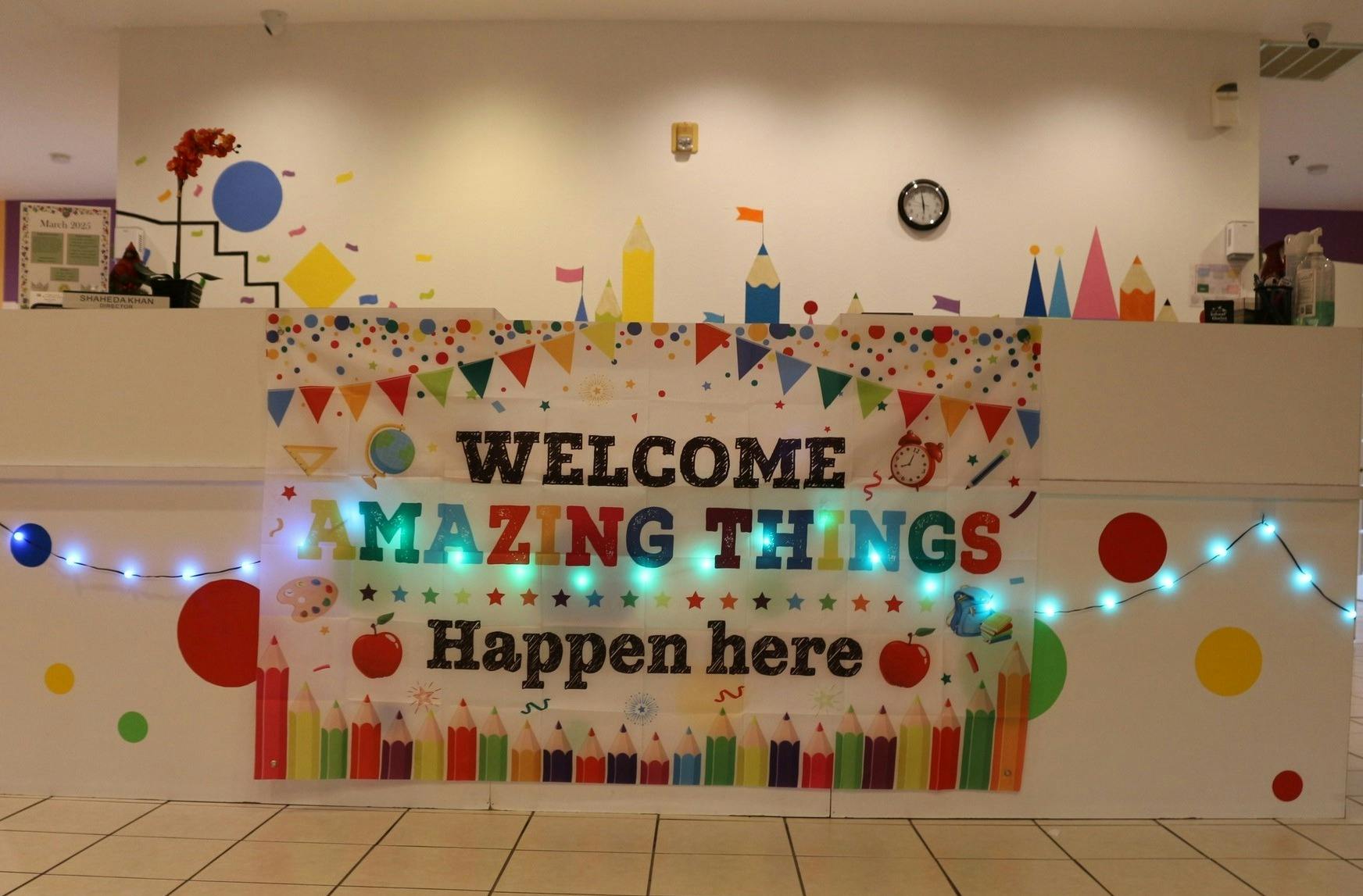 Welcome Amazing Things Happen Here sign with string lights