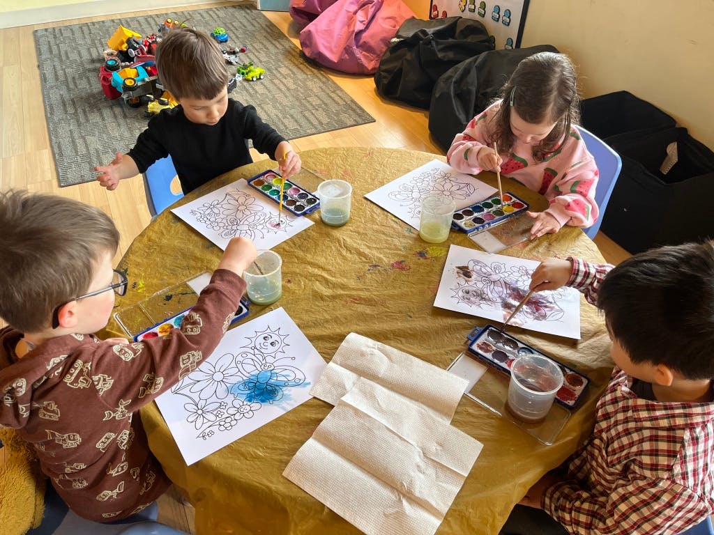 Children painting at a table