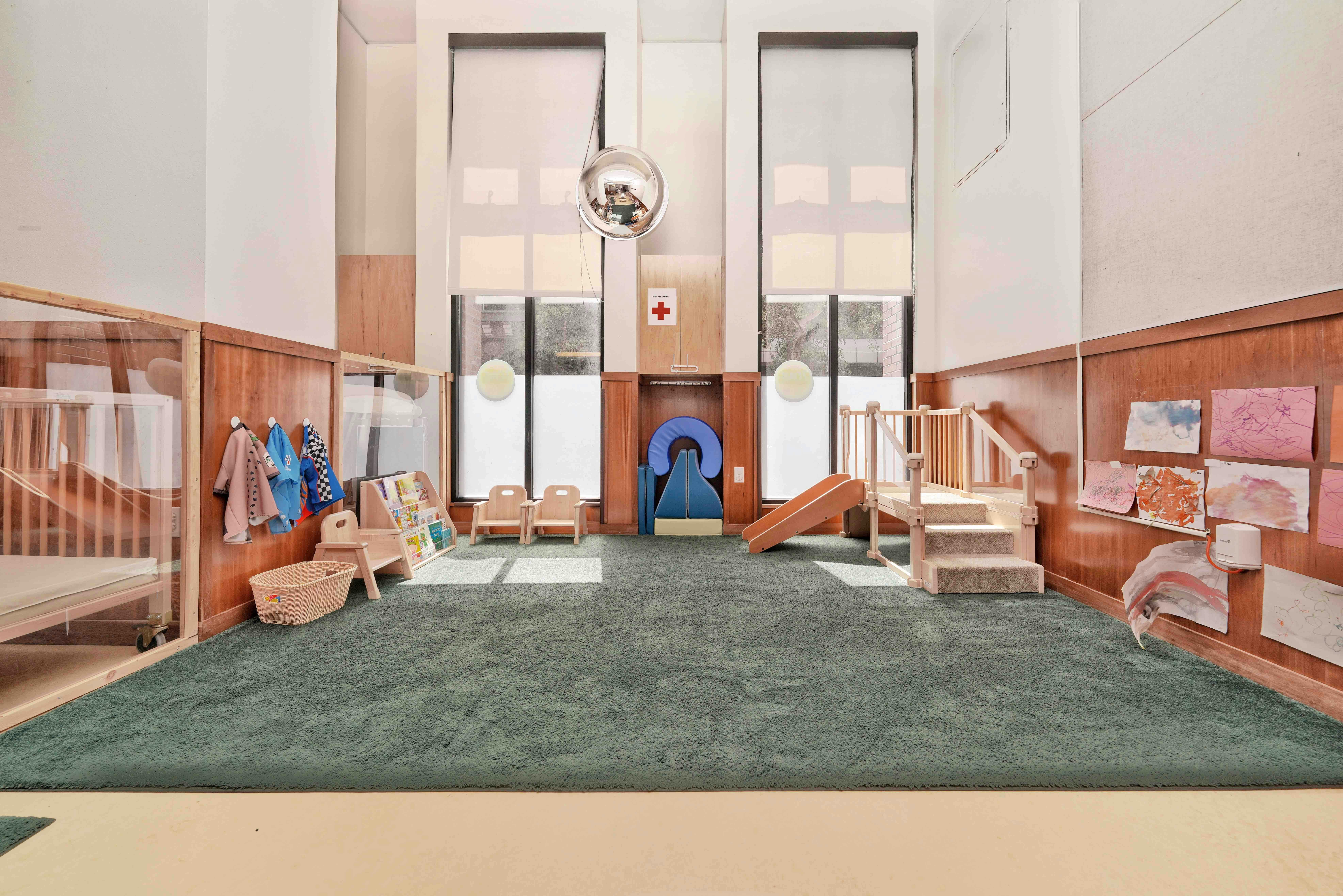 Childcare classroom interior with small furniture and play equipment