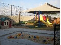 Playground with slide, playhouse, and sandbox