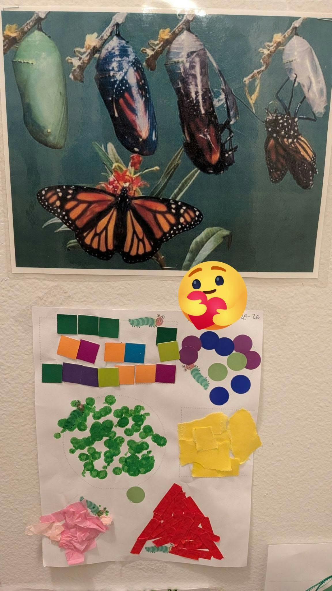 Monarch butterfly and chrysalises stages above a child's colorful paper craft