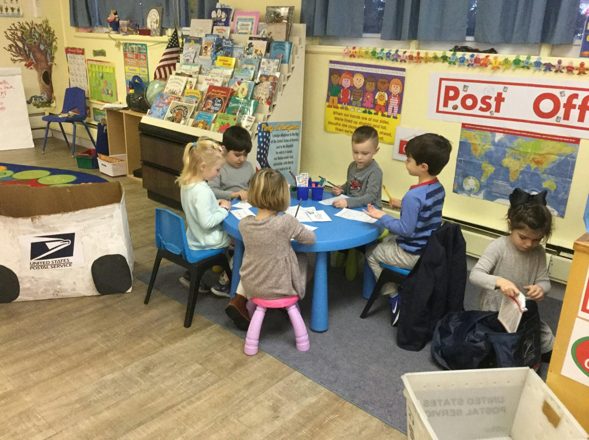 Children sitting at a table in a classroom