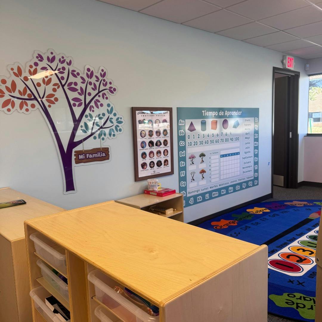 Classroom with learning posters on the wall and wooden storage units