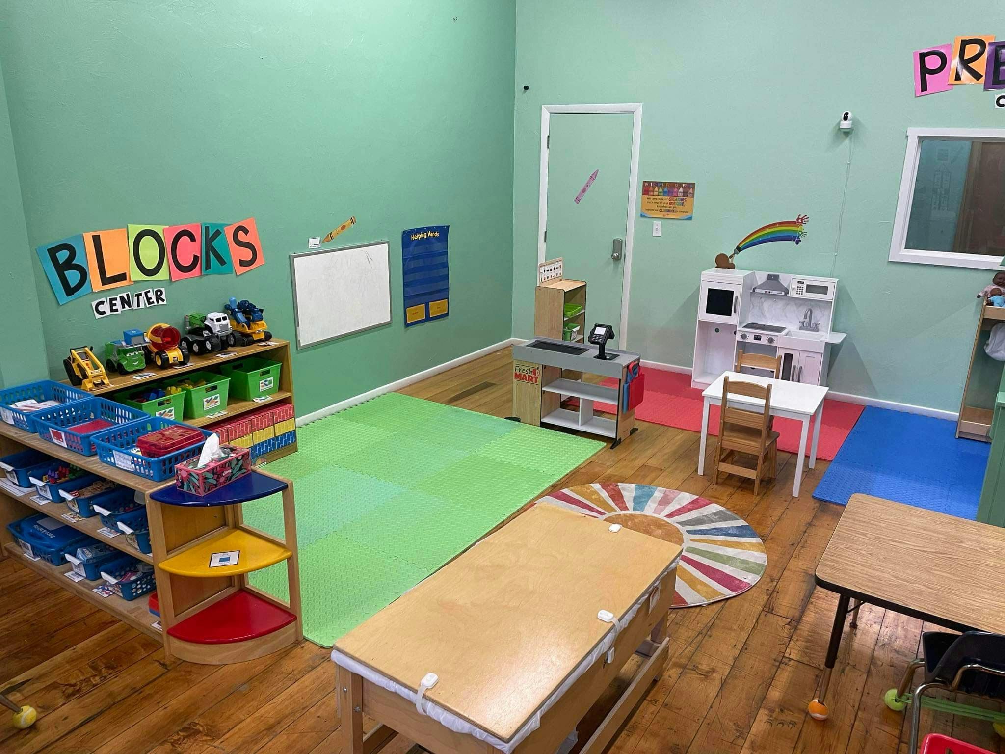 Playroom with toy kitchen, block center, and tables