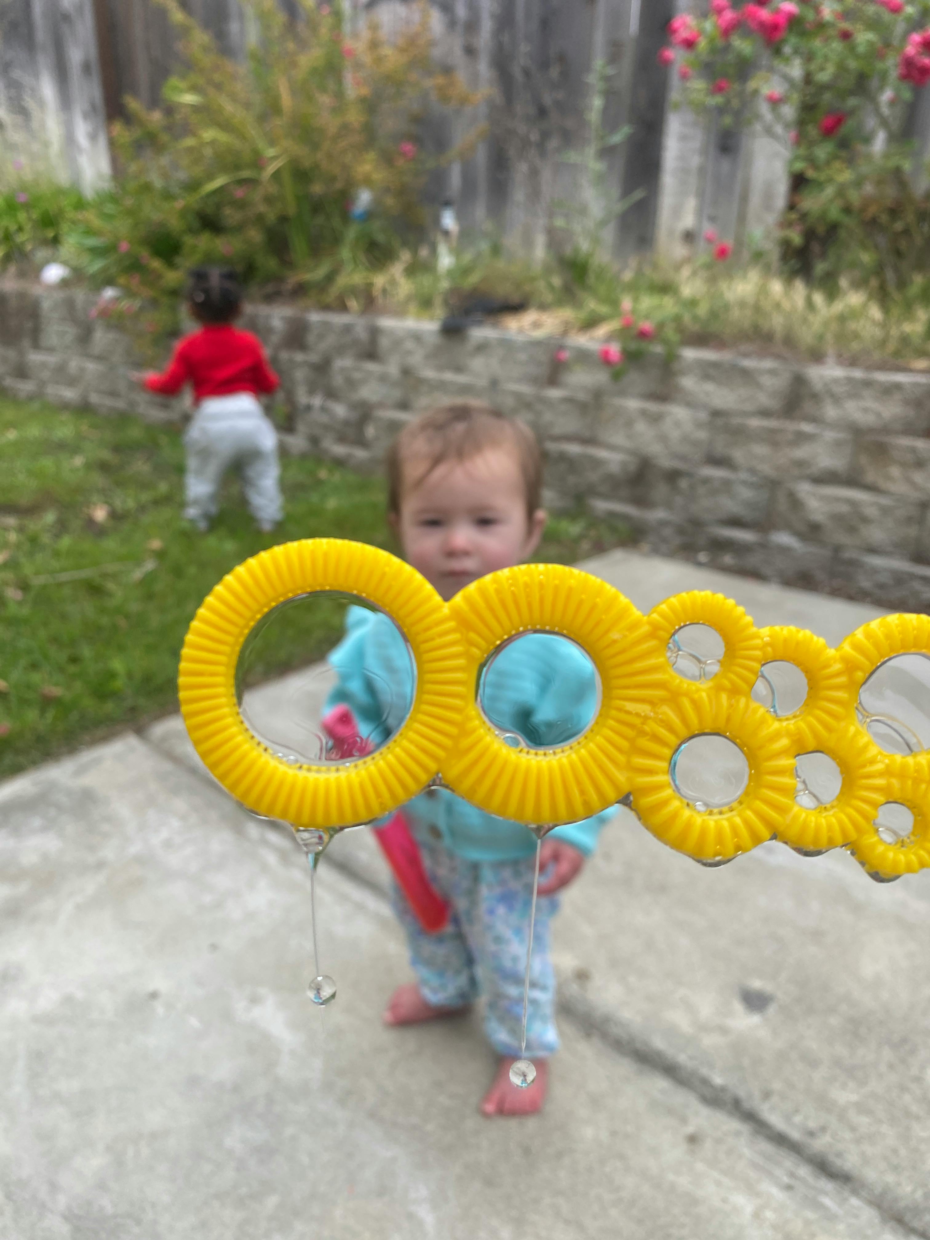 Child looking at a bubble wand