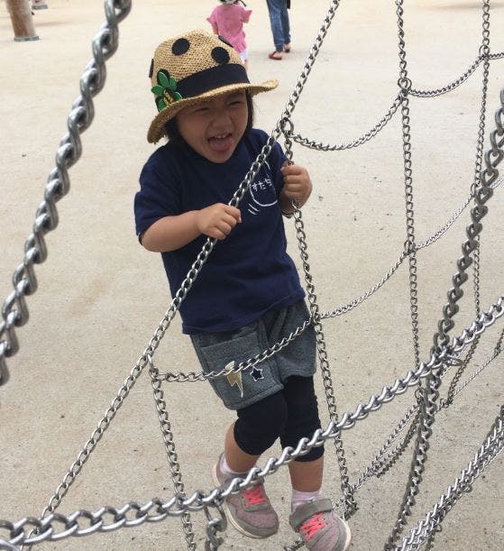 Child climbing on a chain structure