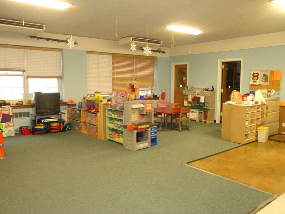 Classroom with toys, shelves, and small tables