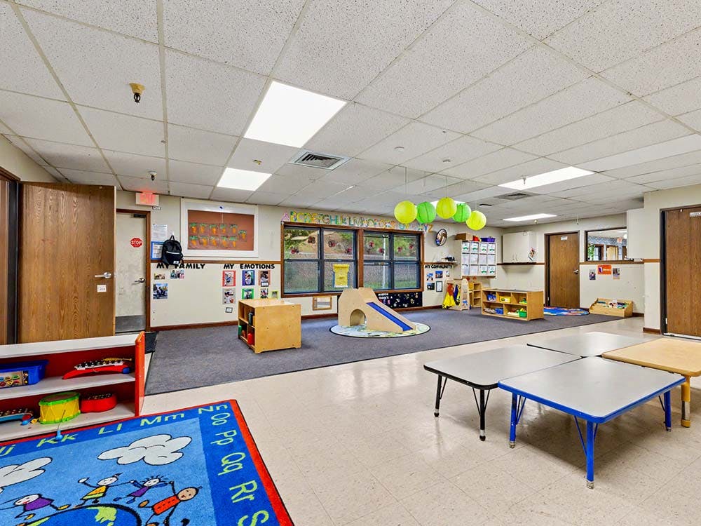 Classroom with children's toys, small tables, and play areas