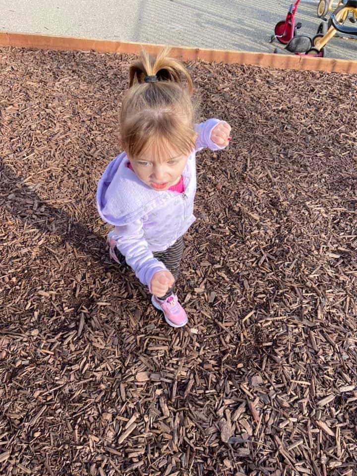 Child walking on wood chips