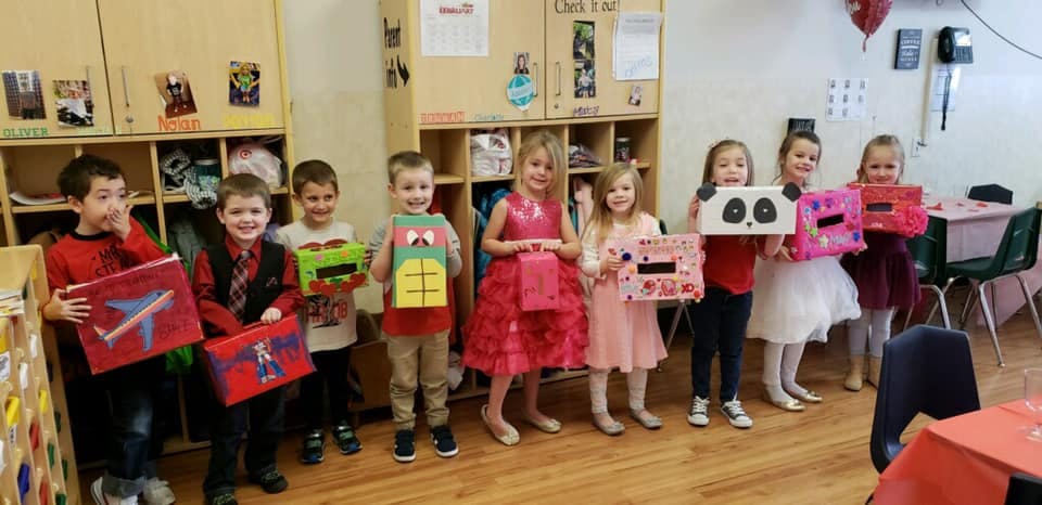 Group of children holding up decorated boxes