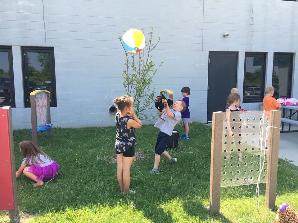 Children playing with a beach ball outdoors