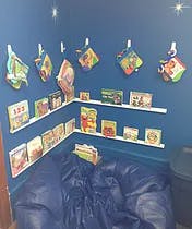 Corner with shelves of books and a beanbag chair