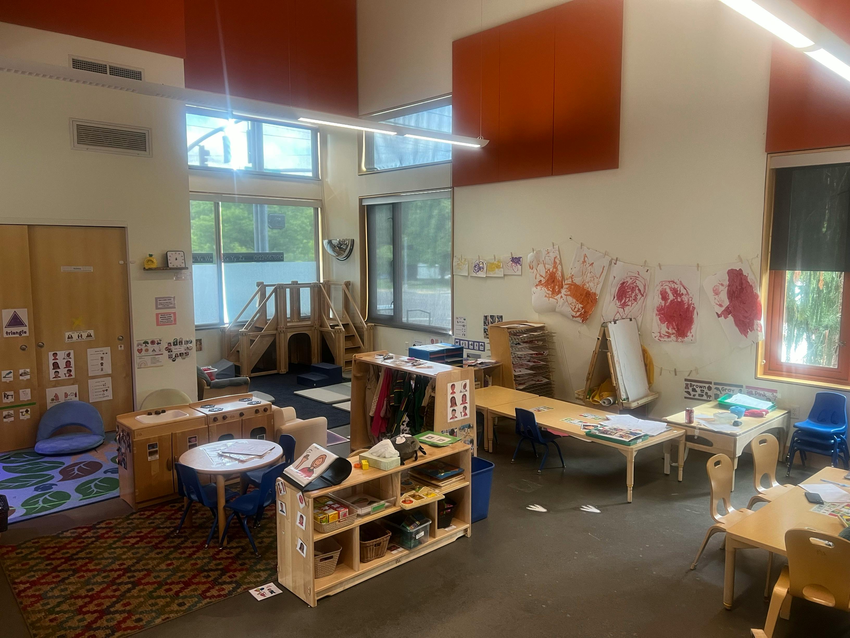 Classroom with tables, chairs, and play structures