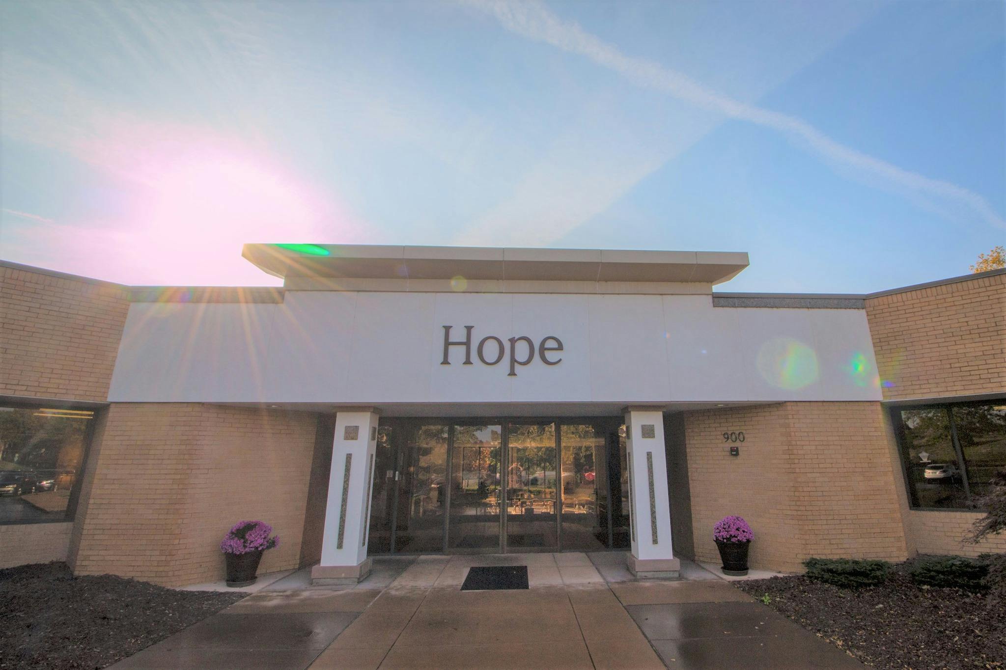 Building exterior with "Hope" sign above entrance