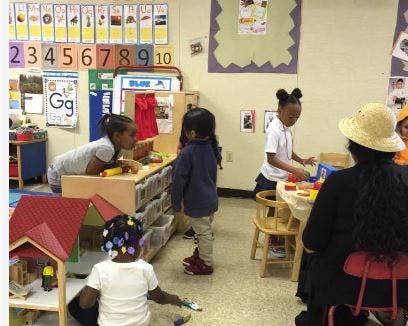 Children and an adult in a classroom