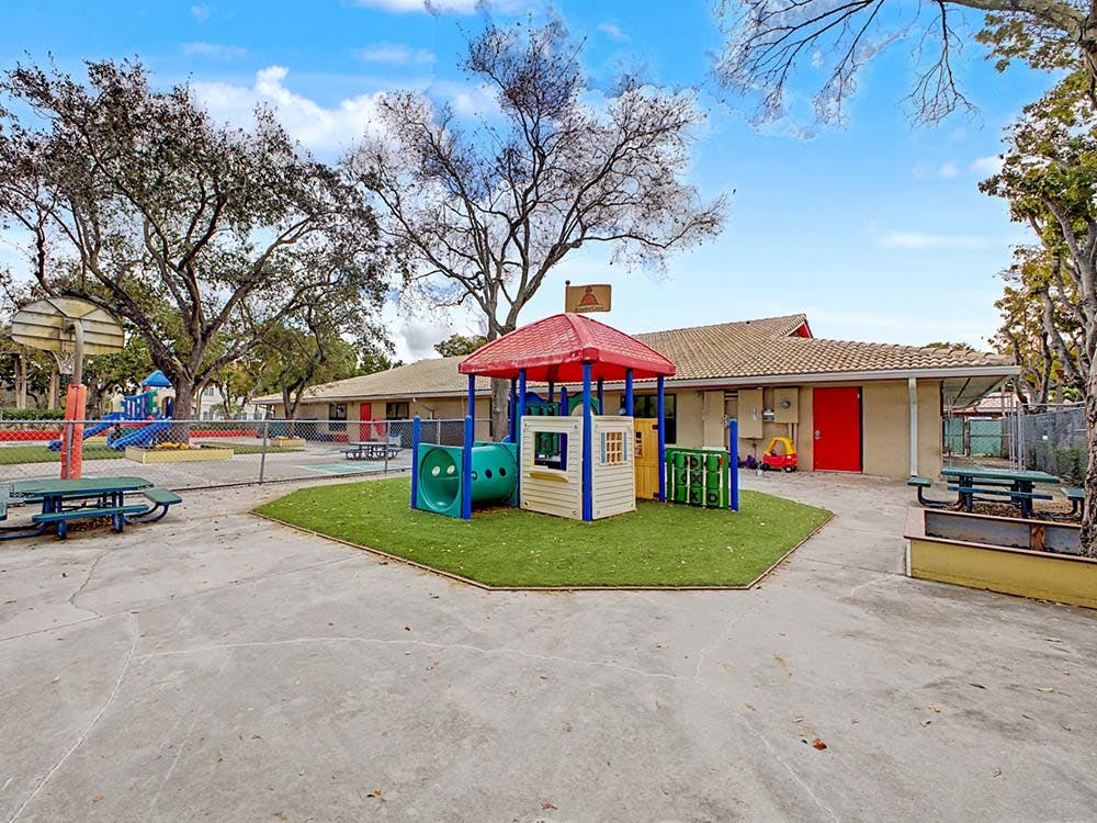 Outdoor playground with colorful play structures and buildings
