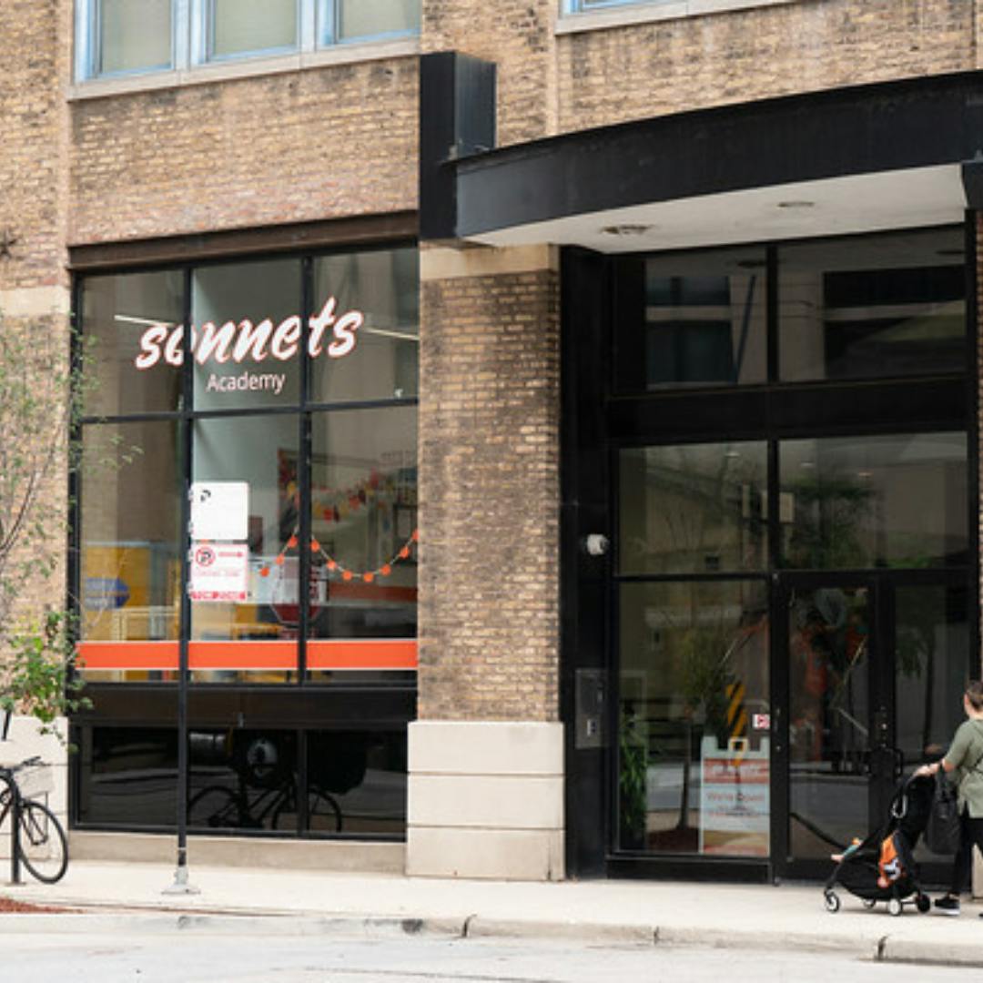 Building exterior with "Sonnets Academy" sign on window