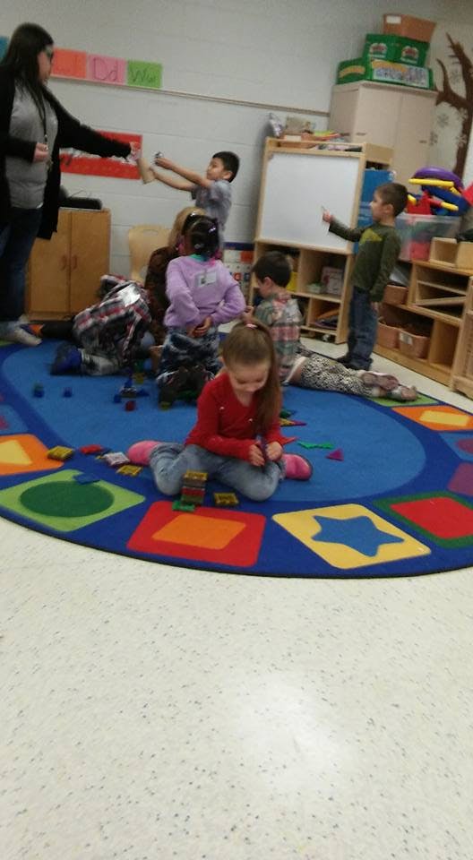 Adult and children in a classroom