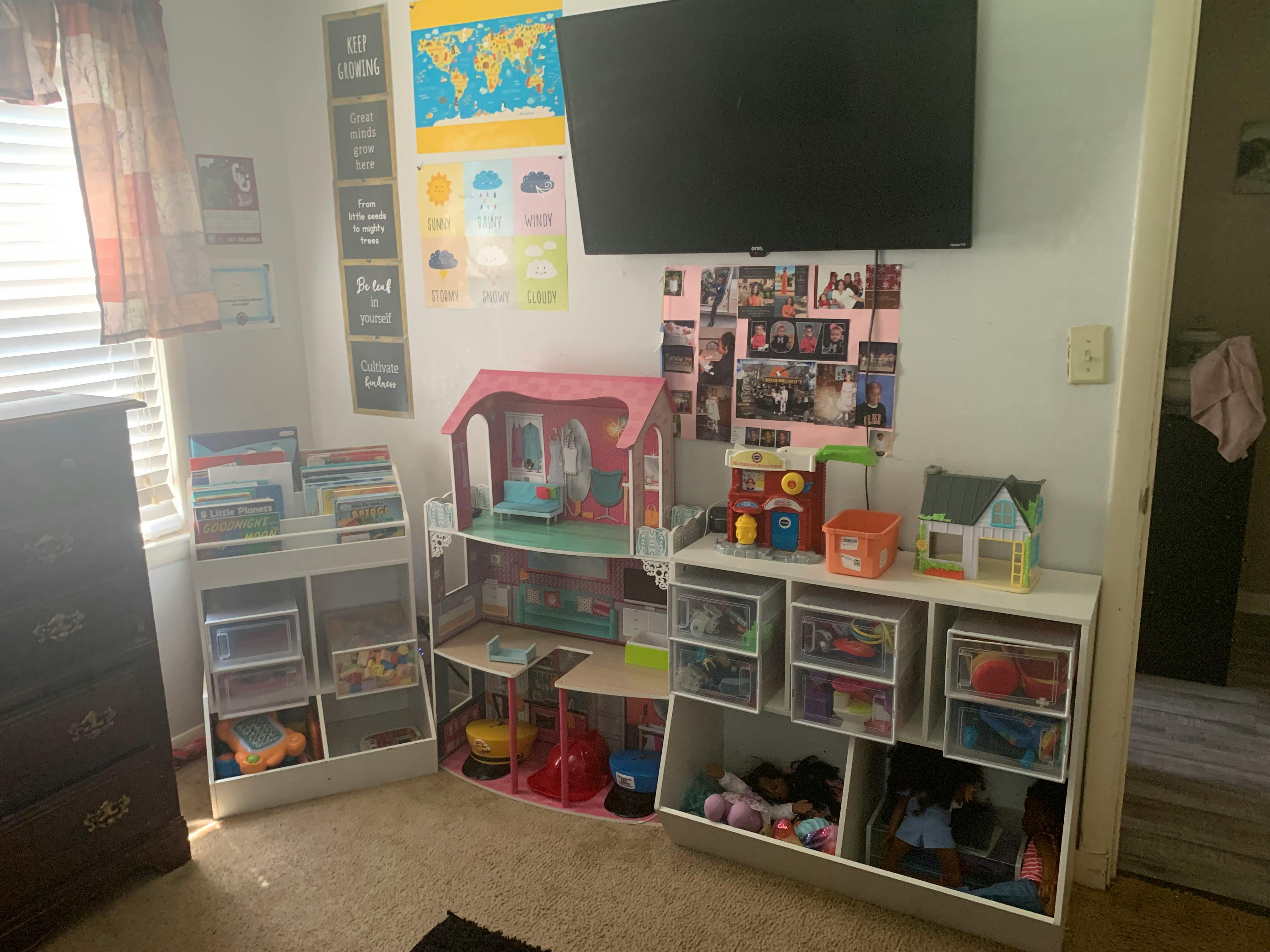 Child's room with dollhouse, toy storage, and wall-mounted TV