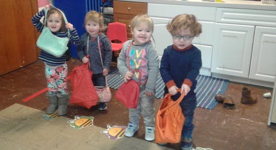 Four children holding bags