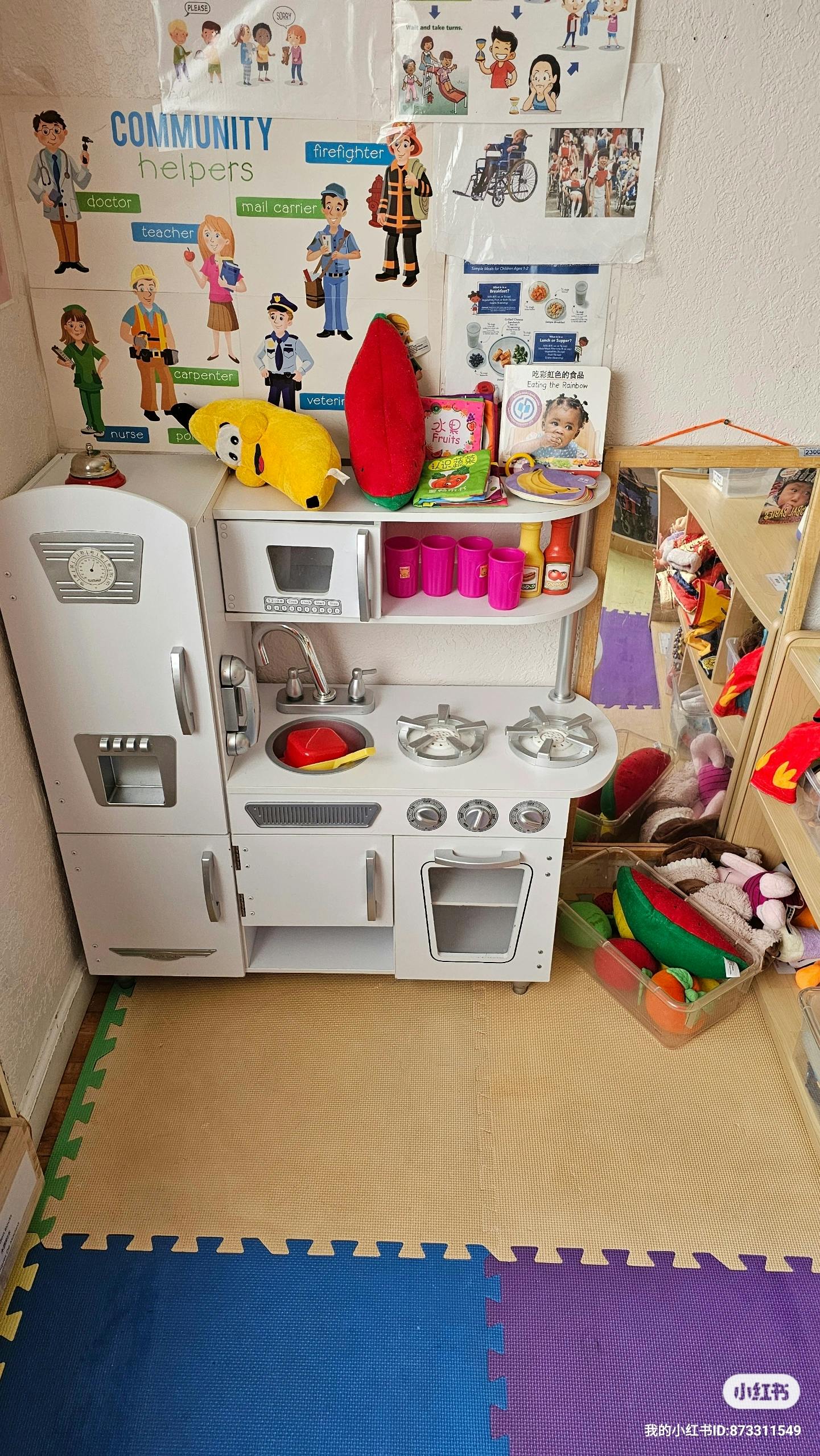 Toy kitchen set with community helpers poster above