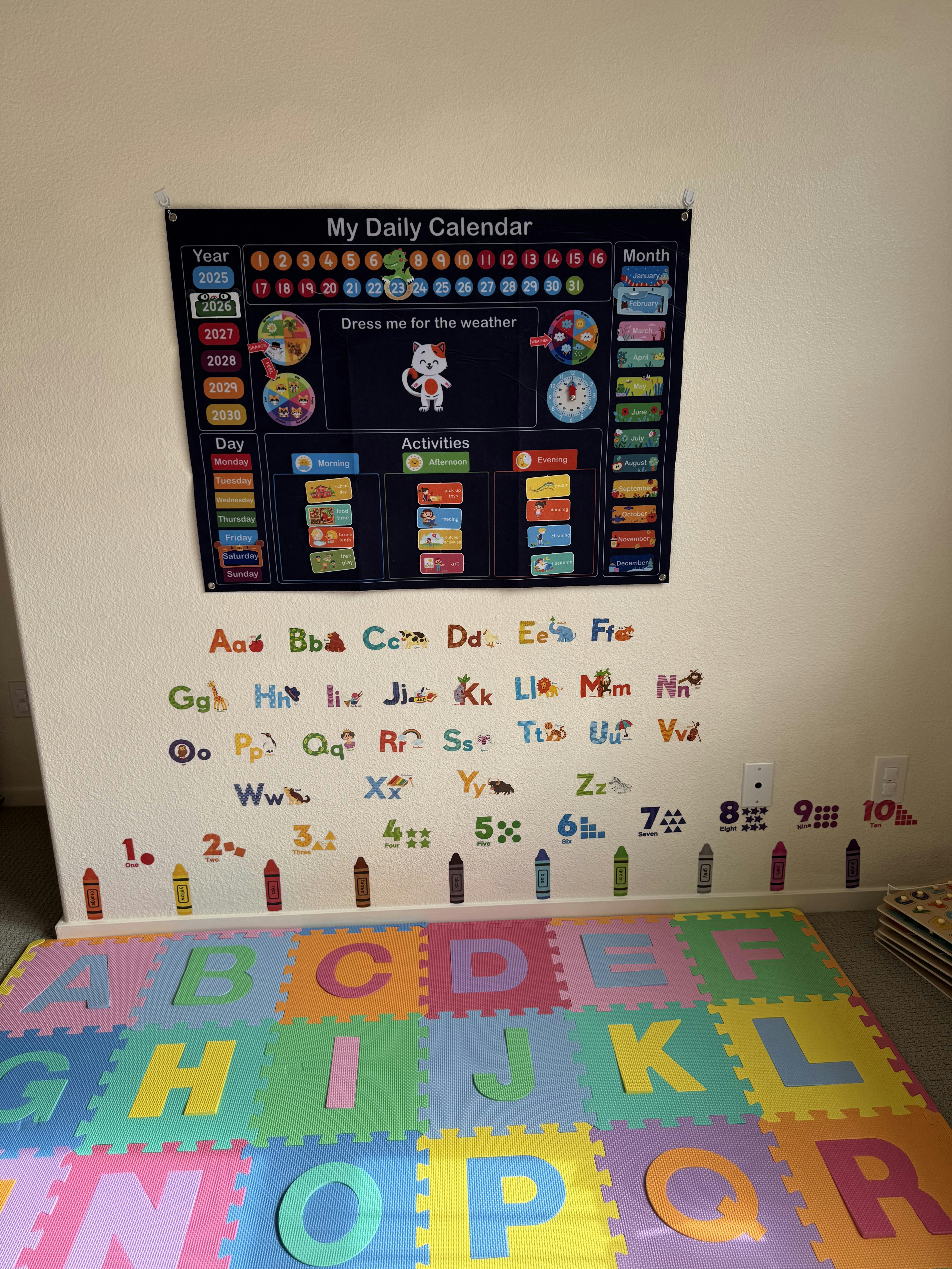 Children's learning tools, including a calendar chart, alphabet and number wall stickers, and foam letter mats