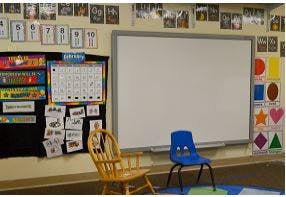 Classroom with whiteboard, bulletin board, and two chairs
