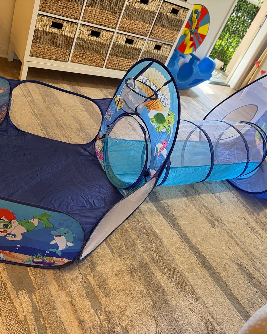 Child's play tunnel and tent on a wooden floor