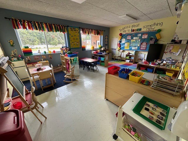 Empty classroom with small tables and chairs