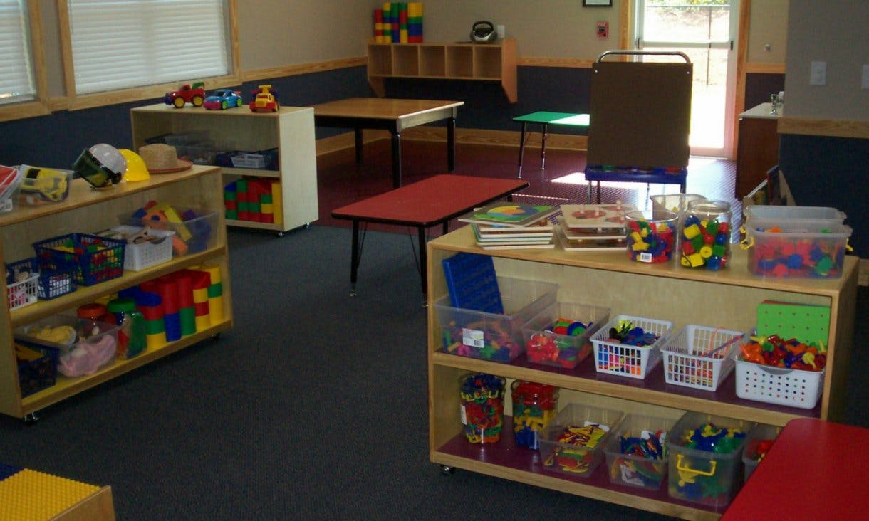 Classroom with shelves of toys and tables