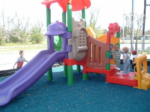 Children playing on a colorful playground structure