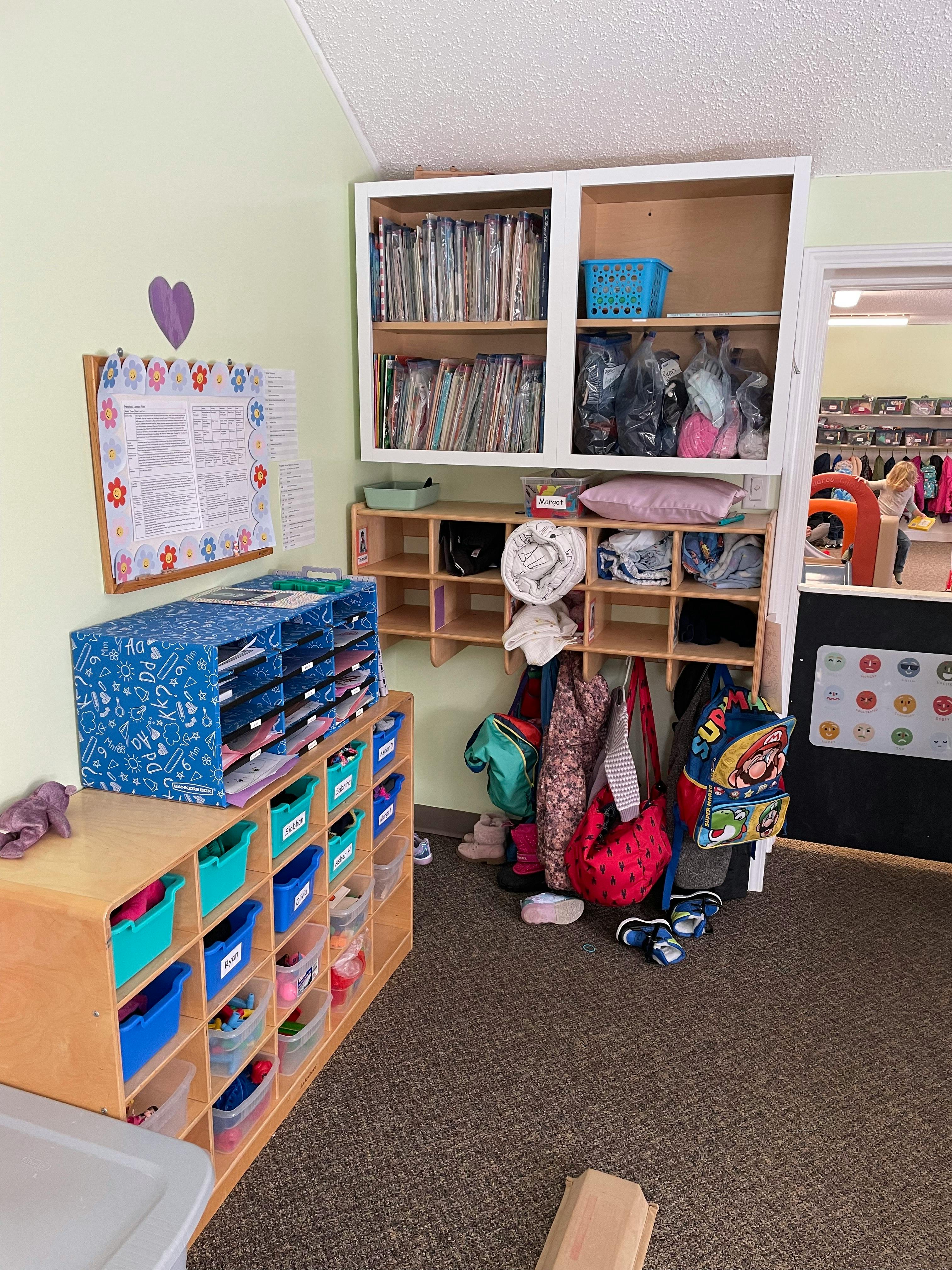 Classroom with cubbies, shelves, and coats hanging