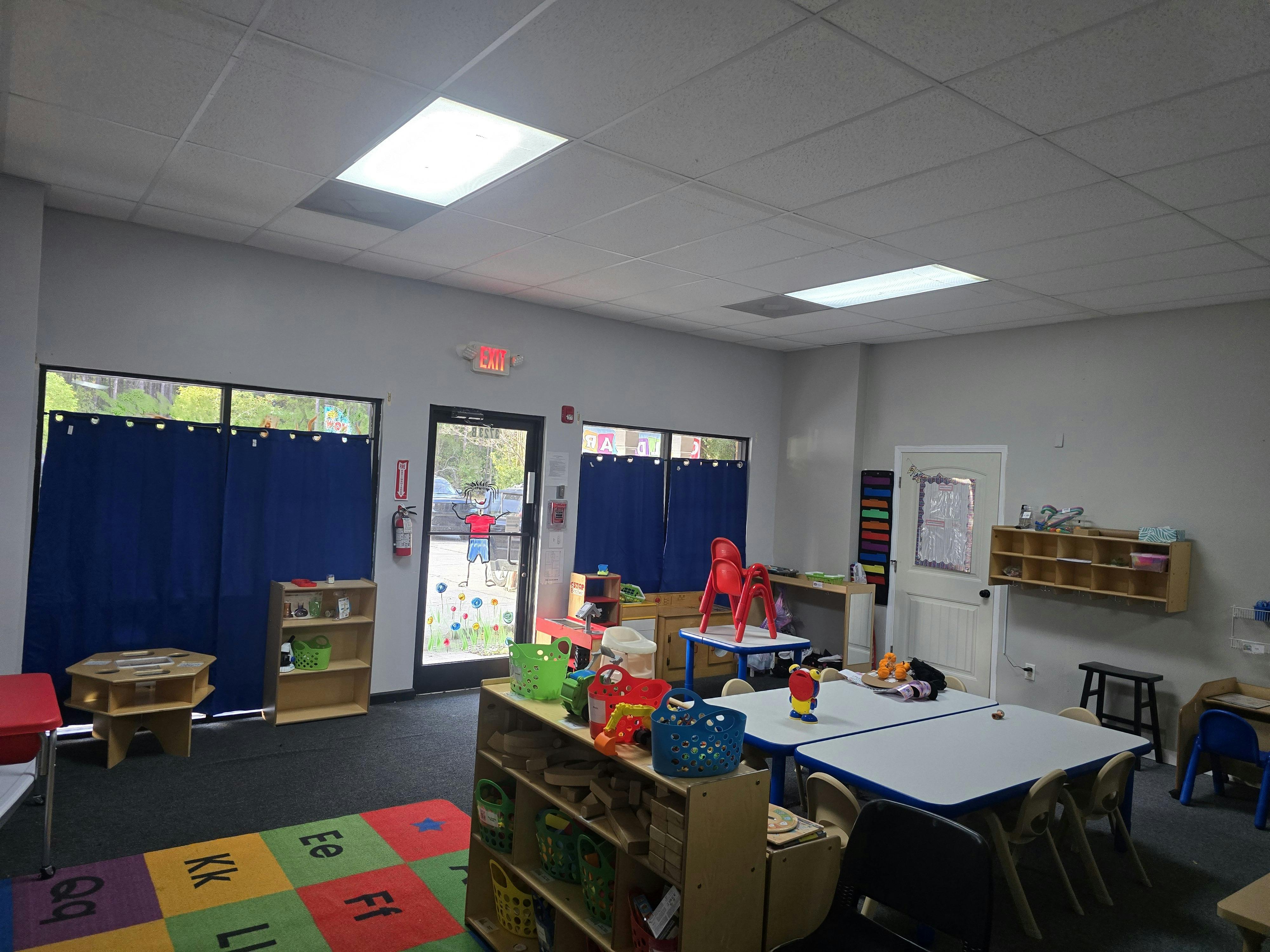 Empty classroom with small tables and chairs